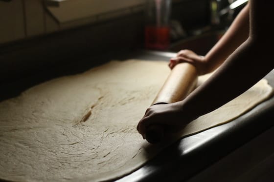 rolling out the dough for cinnamon rolls