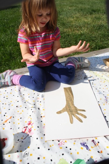 toddler tracing hand on brown paper