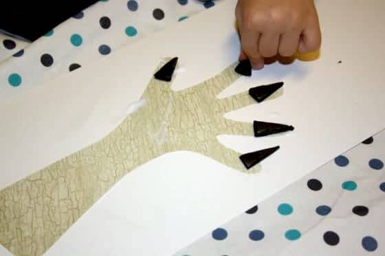 child gluing foam fingernail