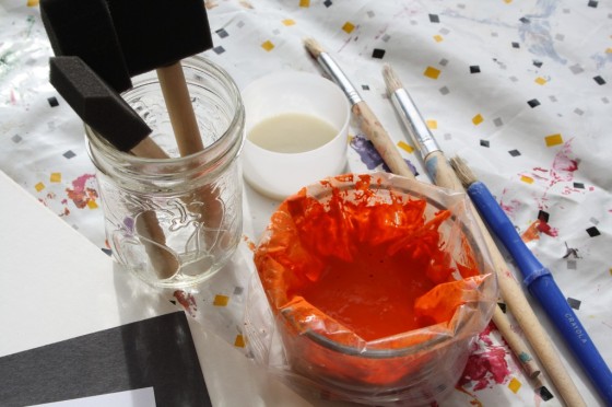 orange paint in ziplock bag in jar