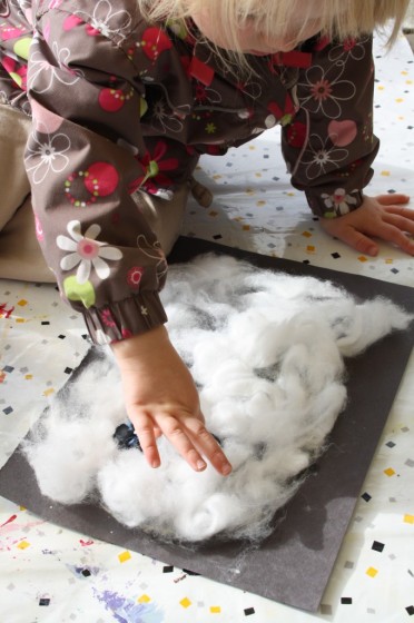 Toddler making a cotton ball ghost craft