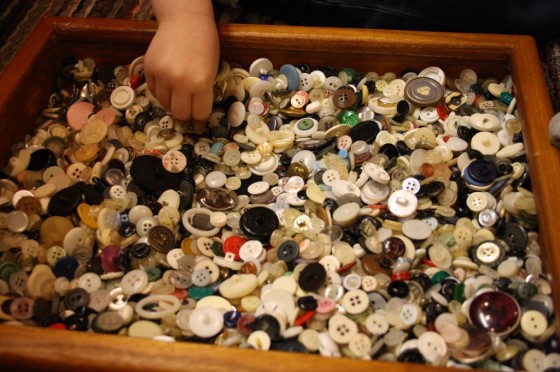 Child choosing buttons for Button Wreath craft