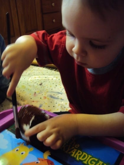 child painting gingerbread house ornament 
