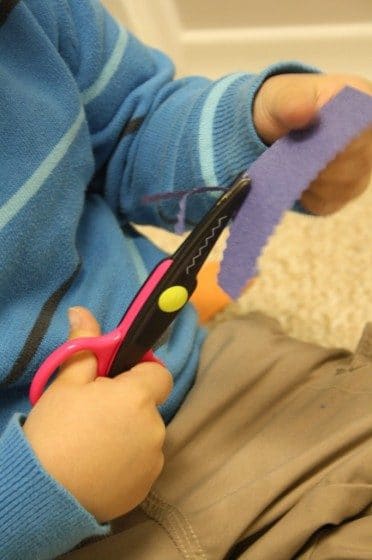 preschooler cutting with zig zag scissors