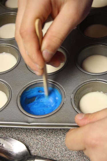 stirring blue homemade watercolour paint