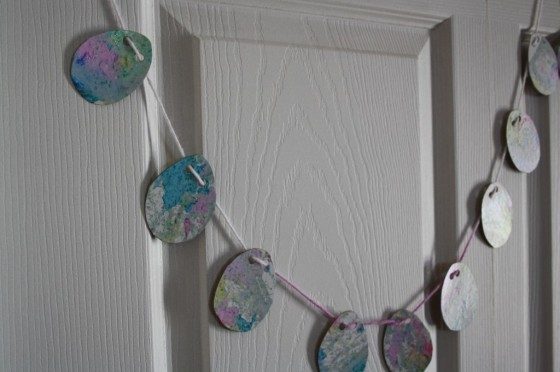 Marbleized Easter Egg Garland hanging from a door.