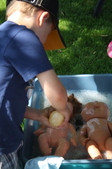 preschooler washing dolls