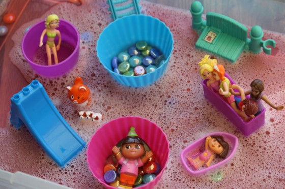 toys in soapy water activity bin
