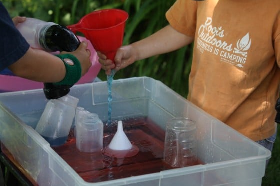 toddlers playing with "waterworks" water science activity bin