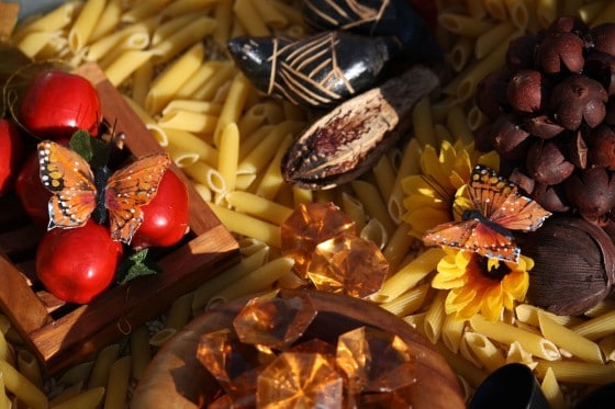 artificial apples, monarchs, amber gems and pinecones in fall bin