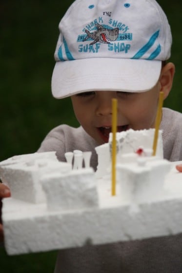toddler building with styrofoam pieces and golf tees