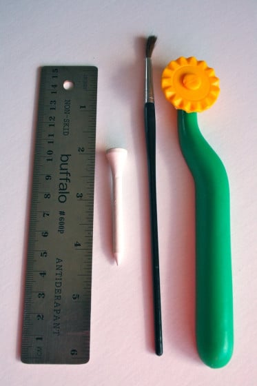pizza cutter, straight ruler and paintbrush handle for styrofoam ornament carving