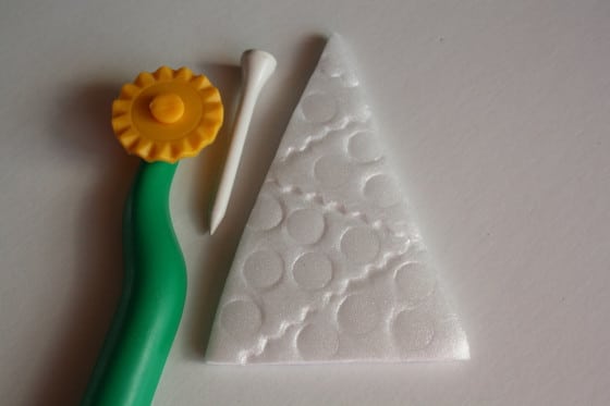 pizza cutter and golf tee to decorate styrofoam ornament