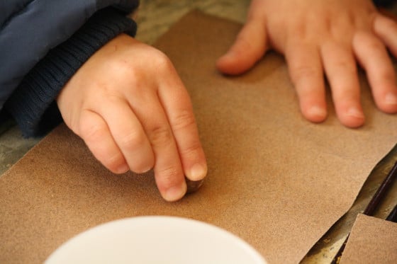 preschooler rubbing nutmeg on sandpaper