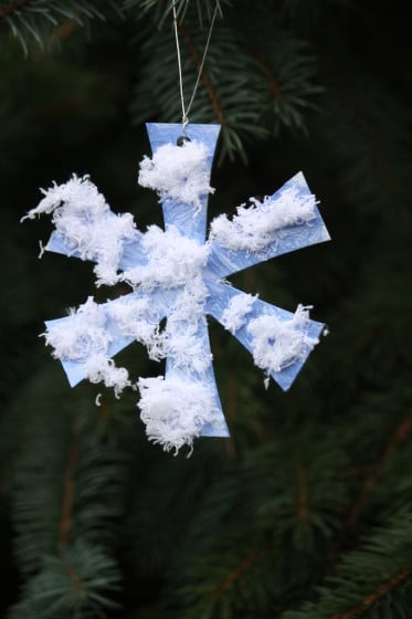 simple snowflake ornament hanging in tree