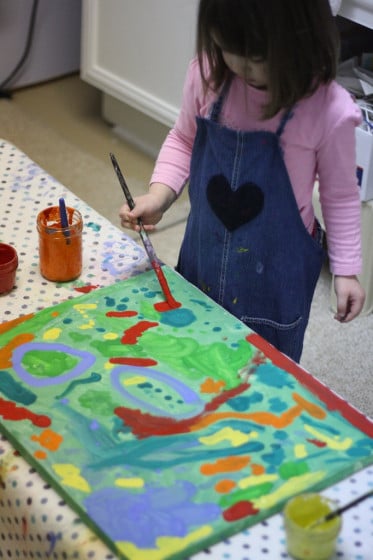 toddler adding the finishing touches to our recycled painting