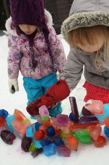 kids building coloured ice sculptures in the backyard