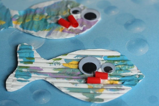 2 painted fish with googly eyes and mouths cut from pieces of a red straw