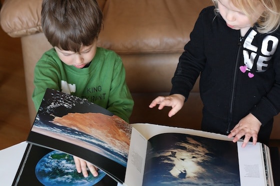 Preschoolers looking at Planet Earth coffee table book