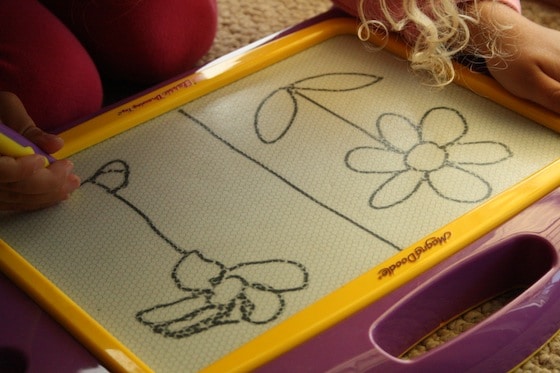 teaching preschooler how to draw a flower on the magna doodle