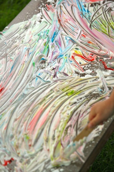sensory art: painting with craft sticks in shaving cream and food colouring 