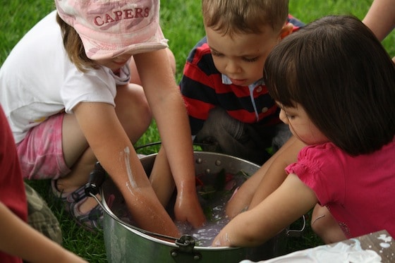 kids washing hands in bucket