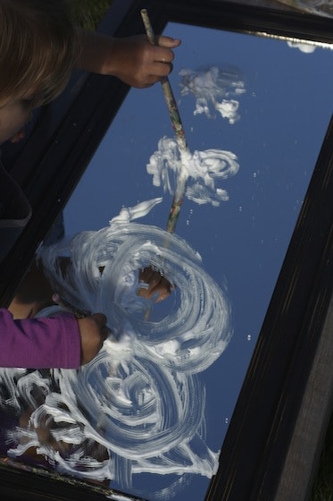Painting clouds on a mirror with shaving cream