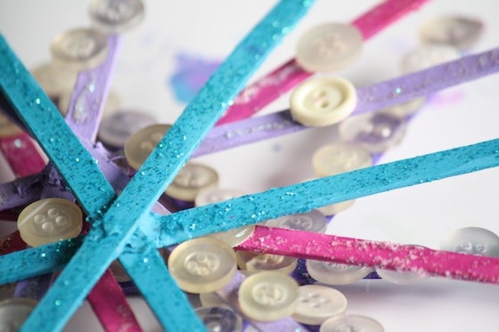 pile of colourful craft stick, button snowflakes