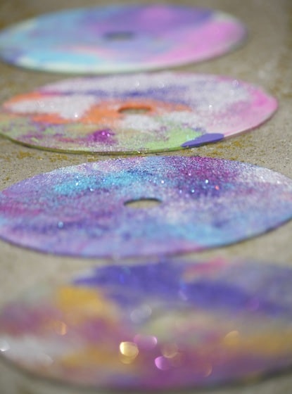 CDs covered in paint and glitter