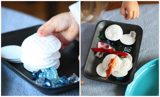 stacking and piling items from the snowman activity tray