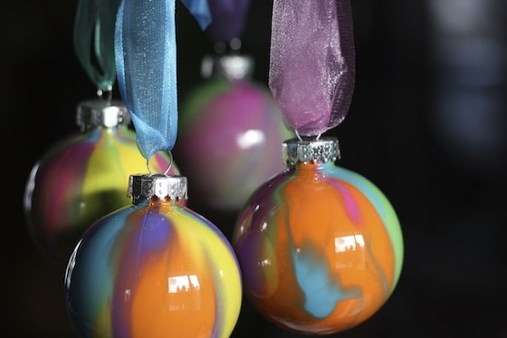 4 pour painted ornaments hanging from organza ribbons