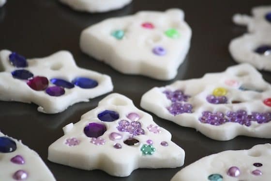 white clay dough ornaments drying on baking sheet