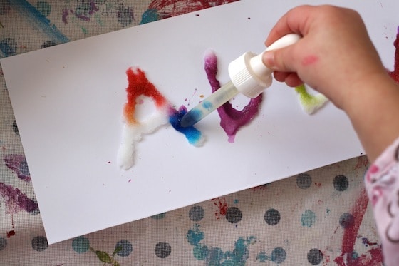 kids dripping watercolours onto salt and white glue