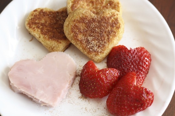 Valentines lunch of heart shaped french toast, ham and strawberries.