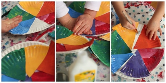 Gluing coloured wedges onto paper plate colour wheel