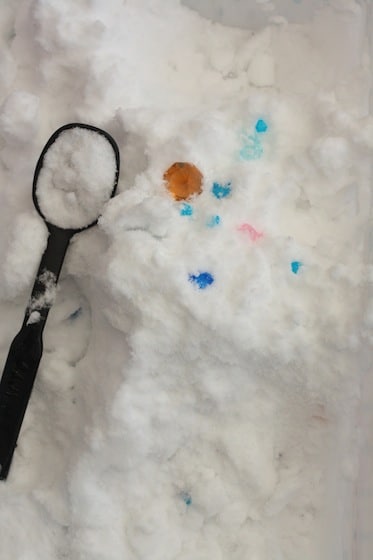 spoon and craft gems in a bin of snow