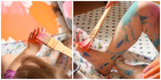 Toddler painting her hands and feet