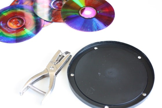 coloured CDS, coffee can lid, hole punch