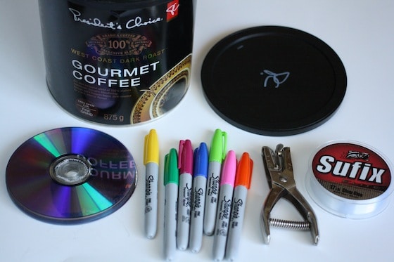 coffee can, cds, sharpies, hole punch, fishing line