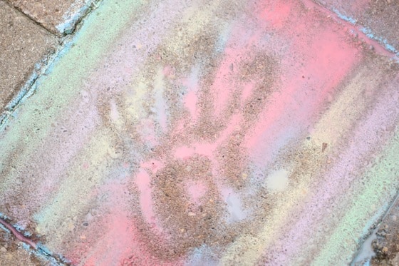 making handprints in wet sidewalk chalk