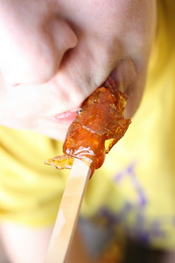 kid eating maple syrup taffy pop