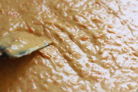 stirring carrot cake batter with spatula