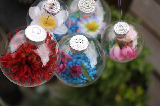 hanging plastic ornaments filled with artificial flowers