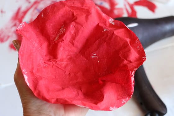 shaping red coffee filter into poppy shape