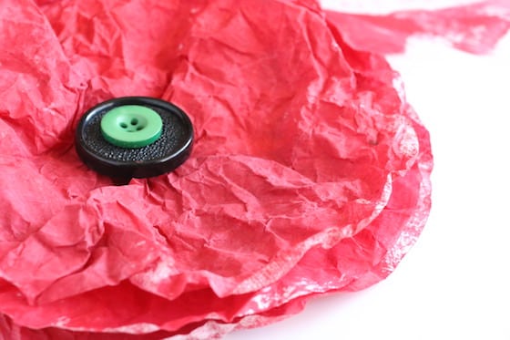 red coffee filters layered with black and green buttons in center