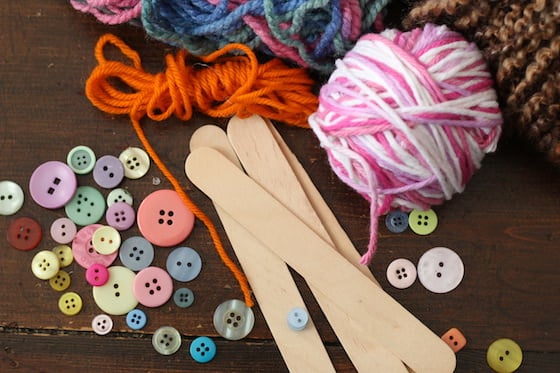 popsicle sticks, buttons, and yarn