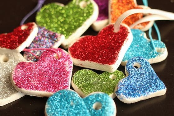pile of glittered white clay dough heart ornaments
