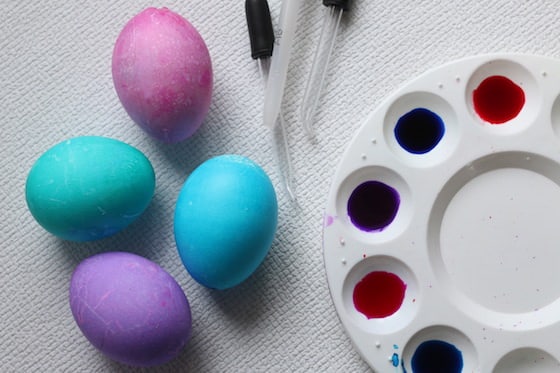 dyed eggs, medicine droppers and liquid watercolours in a pallet