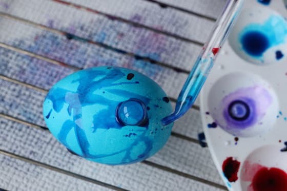 dripping blue watercolours on an easter egg