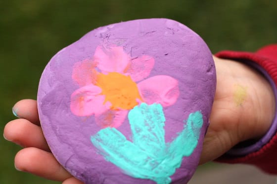 flower painted on rock by a child